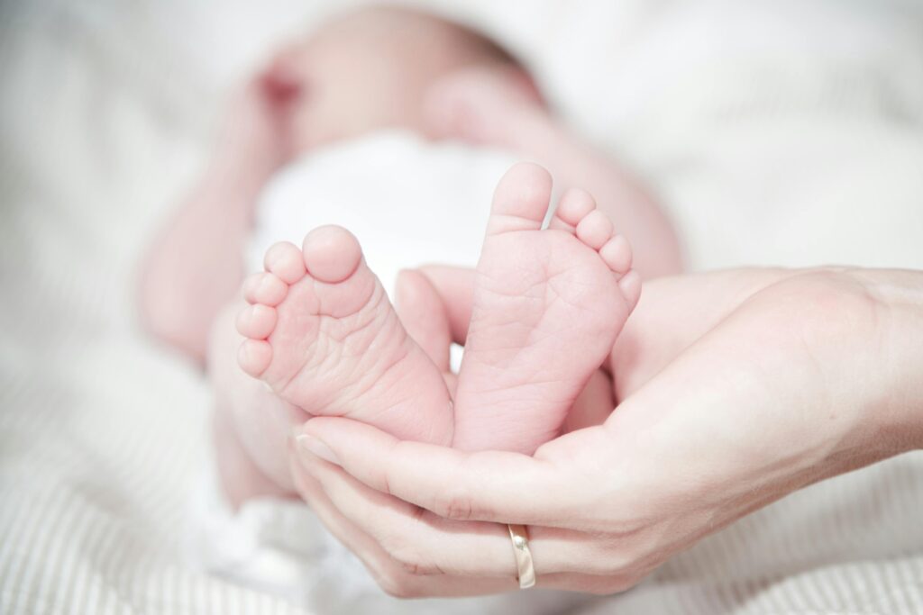 Woman holding a baby's feet