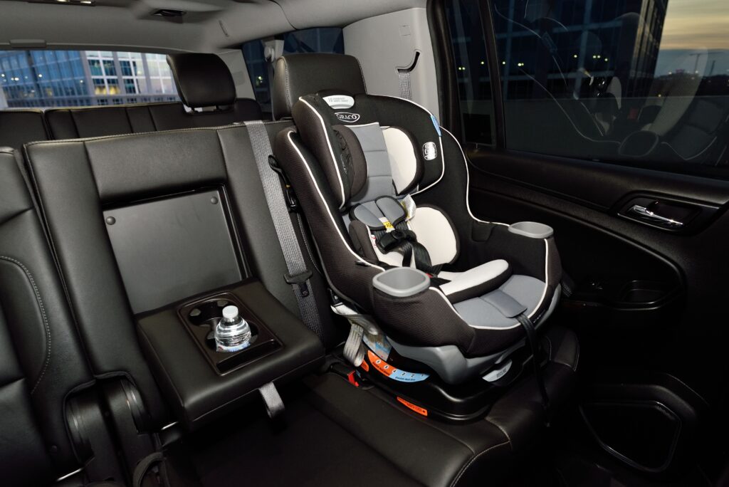 Inside of black interior car with baby seat in backseat