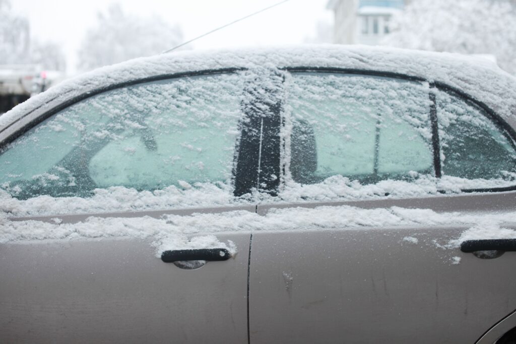 Side of car with snow dusting the windows and roof