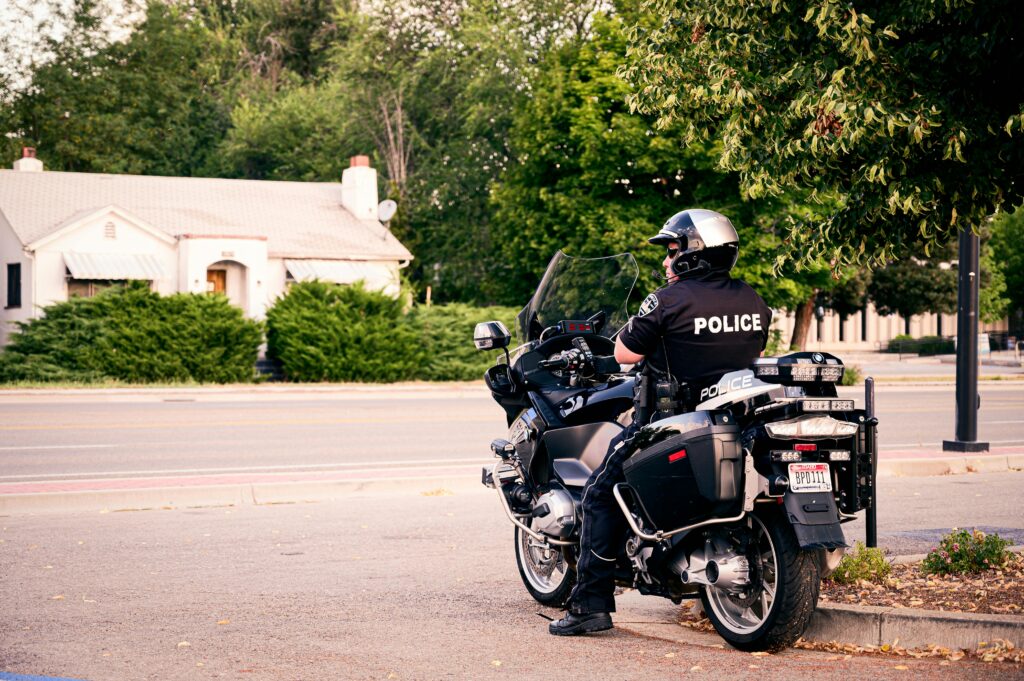 Police officer sitting on a motorcycle outside