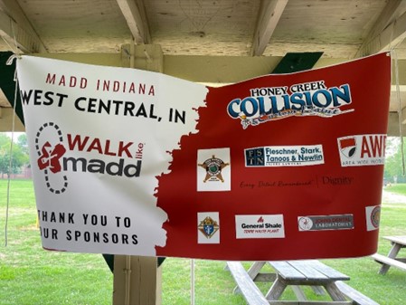 A banner is shown hanging that says "MADD Indiana: West Central Walk Like MADD". A list of sponsors are shown on the banner, including FSTN.
