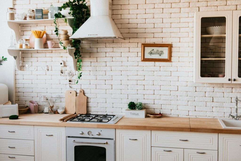 A kitchen with a counter, oven, and sink