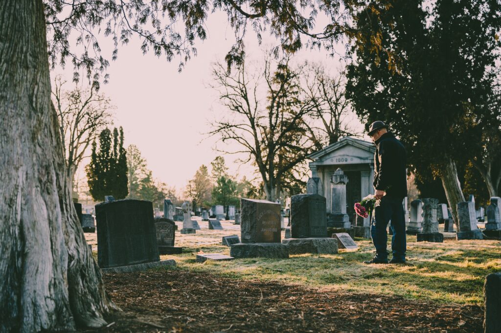 Man at the cemetery with flowers