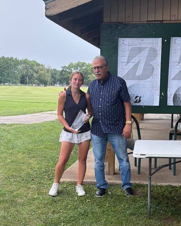 Anthony Tanoos of Fleschner, Stark, Tanoos & Newlin presents the Travis J. Smith Outstanding Junior Golfer Award to Holly Clapp