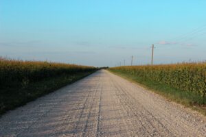 Rural country road running through farm fields near Cloverdale, Indiana